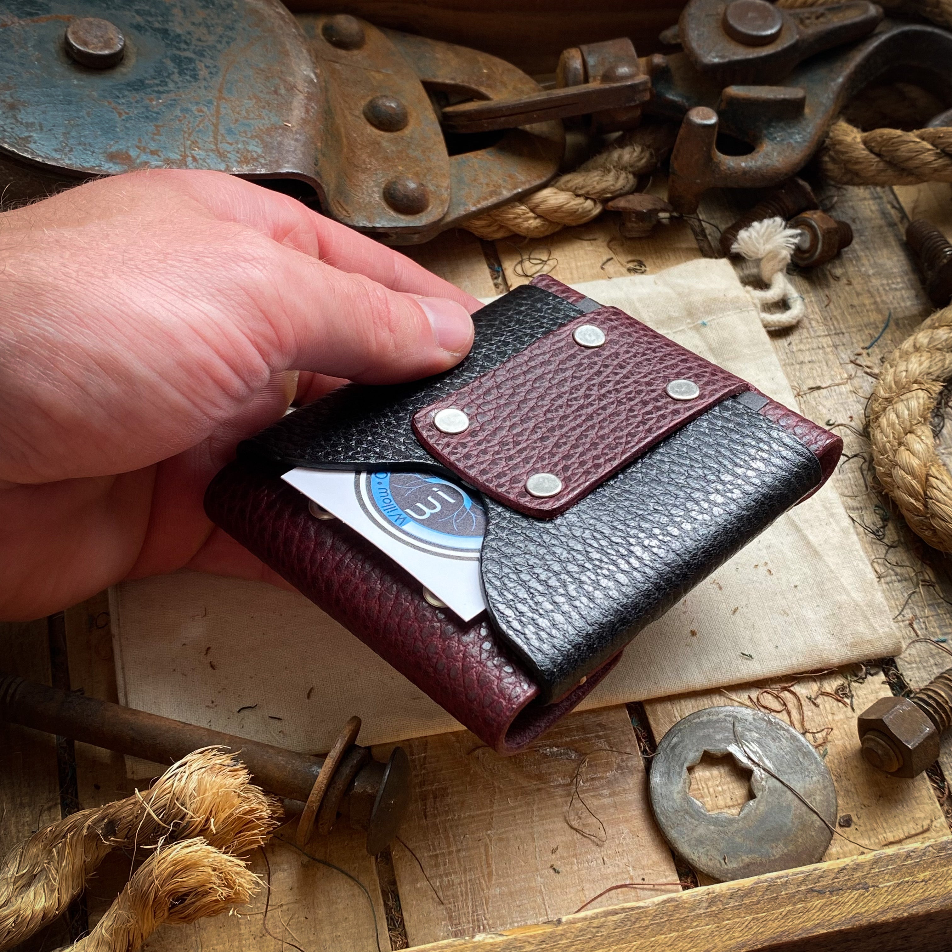 red and black wide luxe minimalist wallet in hand